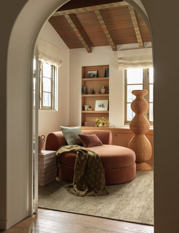 #color::marigold-and-ivory | Fania lightweight linen-cotton blend floral motif throw draped over a chaise.