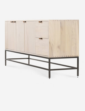 Right side view of the Rosamonde natural wood sideboard with brown leather pulls and a metal base