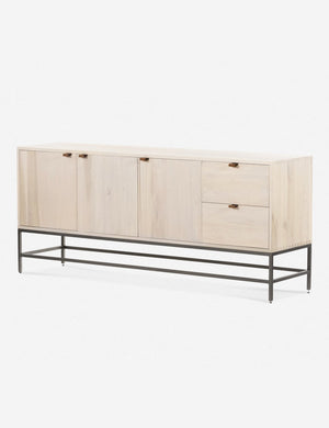 Angled right side view of the Rosamonde natural wood sideboard with brown leather pulls and a metal base