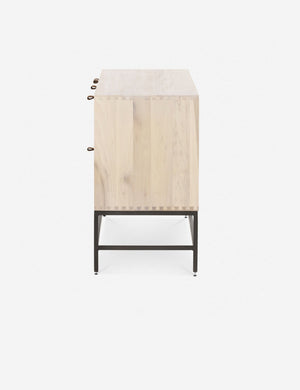 Side view of the Rosamonde natural wood sideboard with brown leather pulls and a metal base