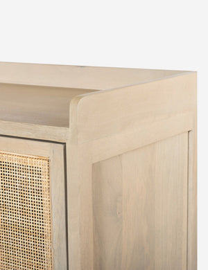 Close-up of the walled exterior surface of the Philene natural mango wood sideboard with cane doors
