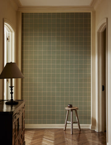 | A hallway with a stool and sideboard cabinet featuring Beddow Grid Wallpaper by Jake Arnold