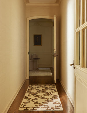 A hallway featuring the Tillar Hand-Knotted Botanical Lattice Wool Rug by Jake Arnold in the runner size.