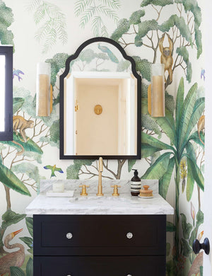 Green Jungle Wallpaper Mural used in a powder room with a black mirror and black vanity.