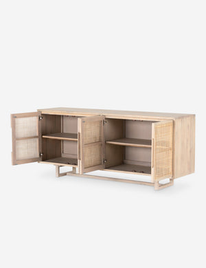 All four doors open on the Margot whitewashed natural mango wood sideboard with cane doors revealing the inner shelving.