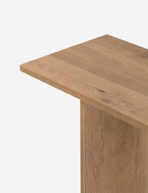 Close up of the top corner of the Remwald sculptural oak wood console table.