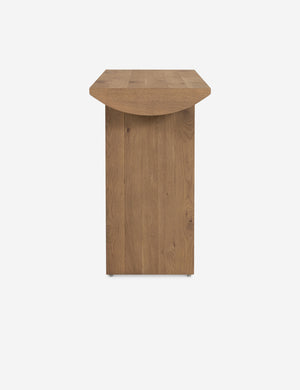 Side view of the Remwald sculptural oak wood console table.