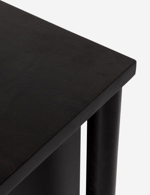 Corner of the Isaura black cane-paneled sideboard cabinet.