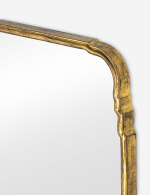 Close up of the top corner of the Teresa thin gold-leaf frame floor mirror.