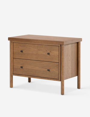 Angled view of the Kisner natural grain oak nightstand.