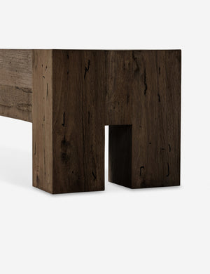 Close up view of the legs of the Bevan chunky leg distressed wood bench in brown.