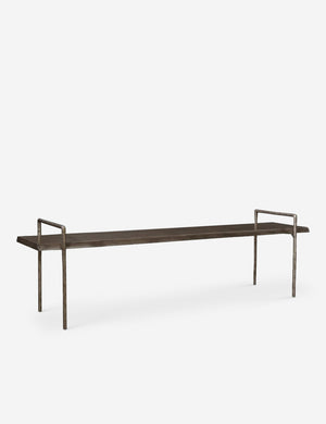 Angled view of the Indrani sleek wooden bench with iron frame.