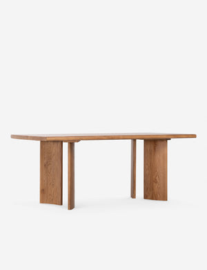 Angled view of the Sun at six crest sienna wood dining table with curved legs