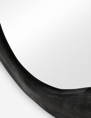 Close-up of the inorganic frame design on the Doreen black organic round mirror