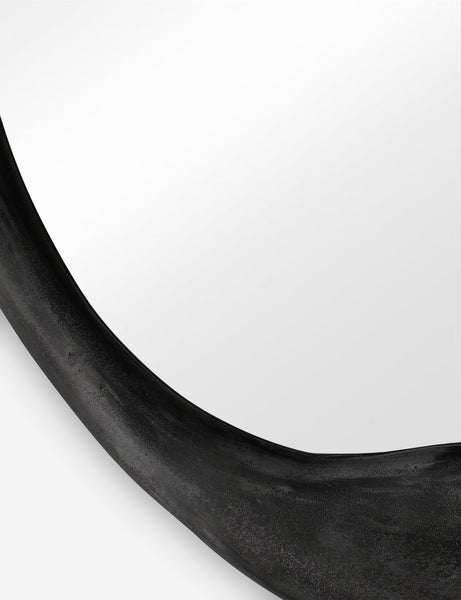 #color::black | Close-up of the inorganic frame design on the Doreen black organic round mirror