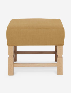 Ambleside Camel yellow linen upholstered ottoman by Ginny Macdonald with a carved frame and vertical channeling on the cushion