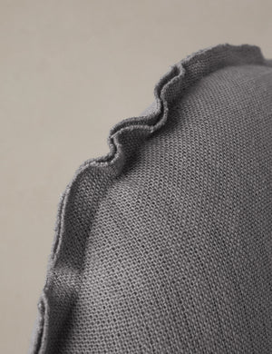 Close up of the Arlo linen flange trim round pillow.