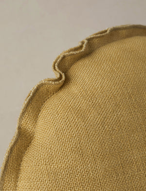 Close up of the Arlo linen flange trim round pillow.