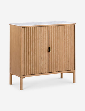 Angled view of the Matija marble top, reeded door front cabinet