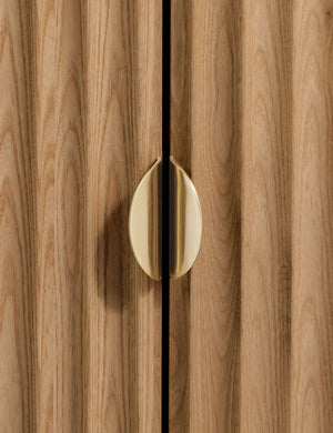 Close up of the door handle of the Matija marble top, reeded door front cabinet