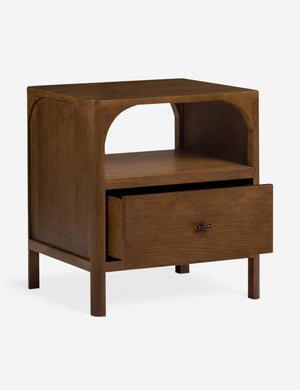 Angled view of the Ralston open shelf walnut nightstand with bottom drawer open