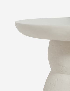 The rim on the top of the Clouded White Round Side Table