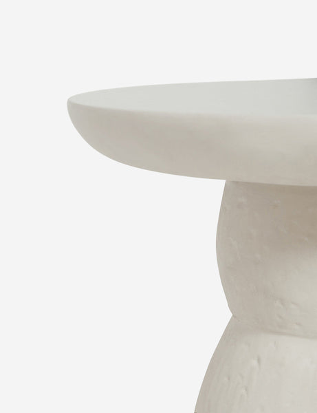 | The rim on the top of the Clouded White Round Side Table