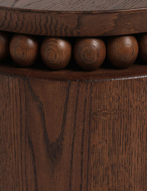 Close up of the Coco round drum beaded wood side table by Carly Cushnie.