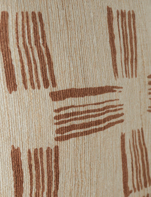 Close up of the pattern of the Crossmarks Silk Pillow by Elan Byrd in terracotta.