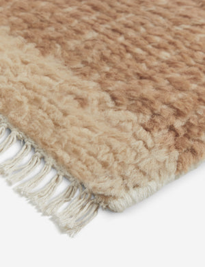 Close up of the corner of the Cyprus striped, tasseled, Moroccan-styled wool rug.