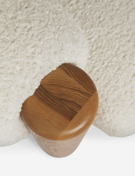 | Bird's-eye view of the wooden leg on the top of the James faux sherpa accent chair