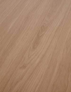 Close up view of the wood grain of the Karine round natural wood pedestal dining table