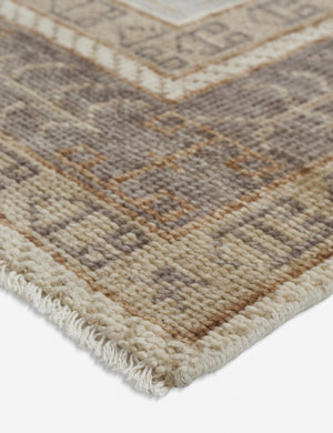 Angled close-up of the corner of the Kate desert palette geometric floor rug