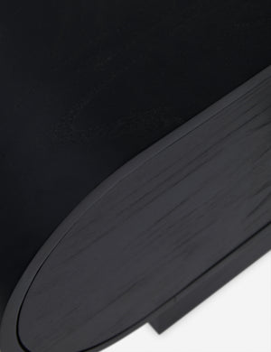 Close up view of the Laughlin retro pill shaped nightstand in black