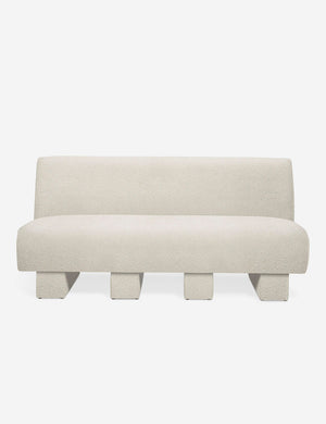 Centerpiece of the Lena white boucle sectional sofa with upholstered beam legs