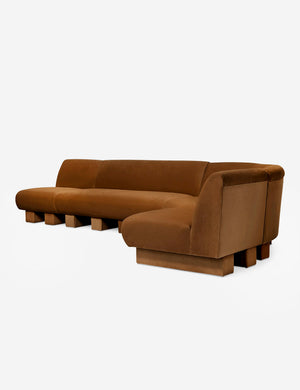 Angled view of the Lena right-facing cognac velvet sectional sofa with upholstered beam legs