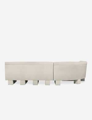Rear view of the entire Lena right-facing white boucle sectional sofa with upholstered beam legs.