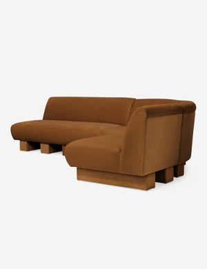 Angled view of the Lena left-facing cognac velvet sectional sofa with upholstered beam legs.