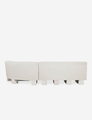 Rear view of the entire Lena right-facing natural linent sectional sofa with upholstered beam legs.