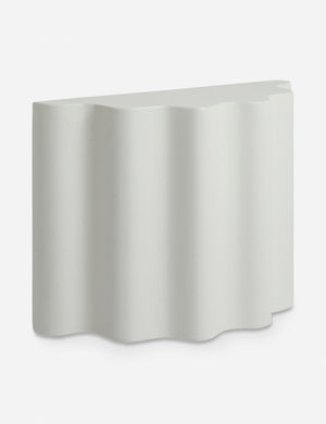 Angled view of the Lune half-moon, scalloped concrete side table