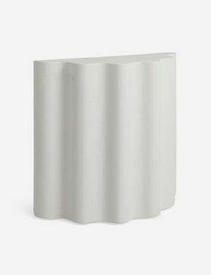 Angled view of the Lune half-moon, scalloped concrete side table