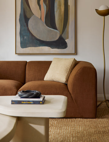 | Sweeney box silhouette abstract print throw pillow styled on a sofa.