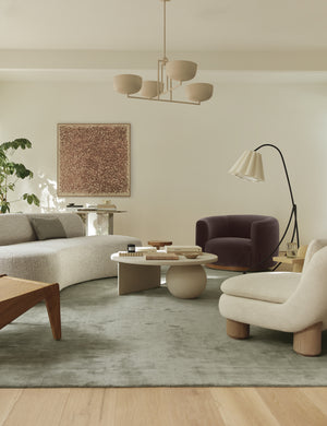 Talley modern sculptural chandelier hanging above a coffee table in a living room.