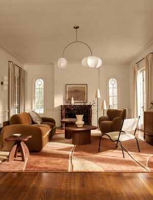 Luneth arc-shape lantern shade linear chandelier by Aimee Song hanging in a living room