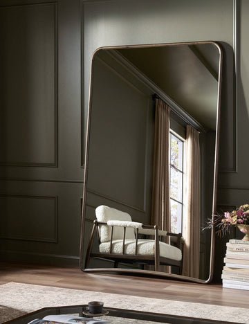 #color::walnut | Picart arched base slim frame floor mirror leaning against a wall