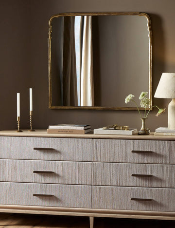 #color::gold | Coudray serpentine gold leaf frame mantel mirror hung above a dresser