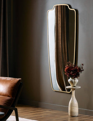Armond crest-shaped slim frame full length mirror hung on a wall