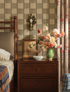Garda ornate floral metalwork wall sconce by Heidi Caillier hung above a nightstand