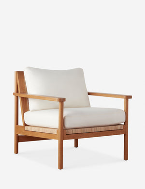 Angled view of the Jutta woven can back accent chair.