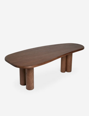 Angled overhead view of the Nave modern sculptural red oak dining table by Aimee Song